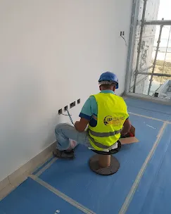IP Care technician terminating a data outlet inside an apartment at Al Jeel Tower