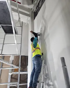 IP Care technician mounting an internal CCTV camera in a corridor at Al Jeel Tower