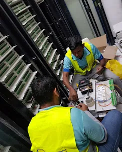 IP Care technicians splicing fiber into an optical distribution frame at Paragon Mall